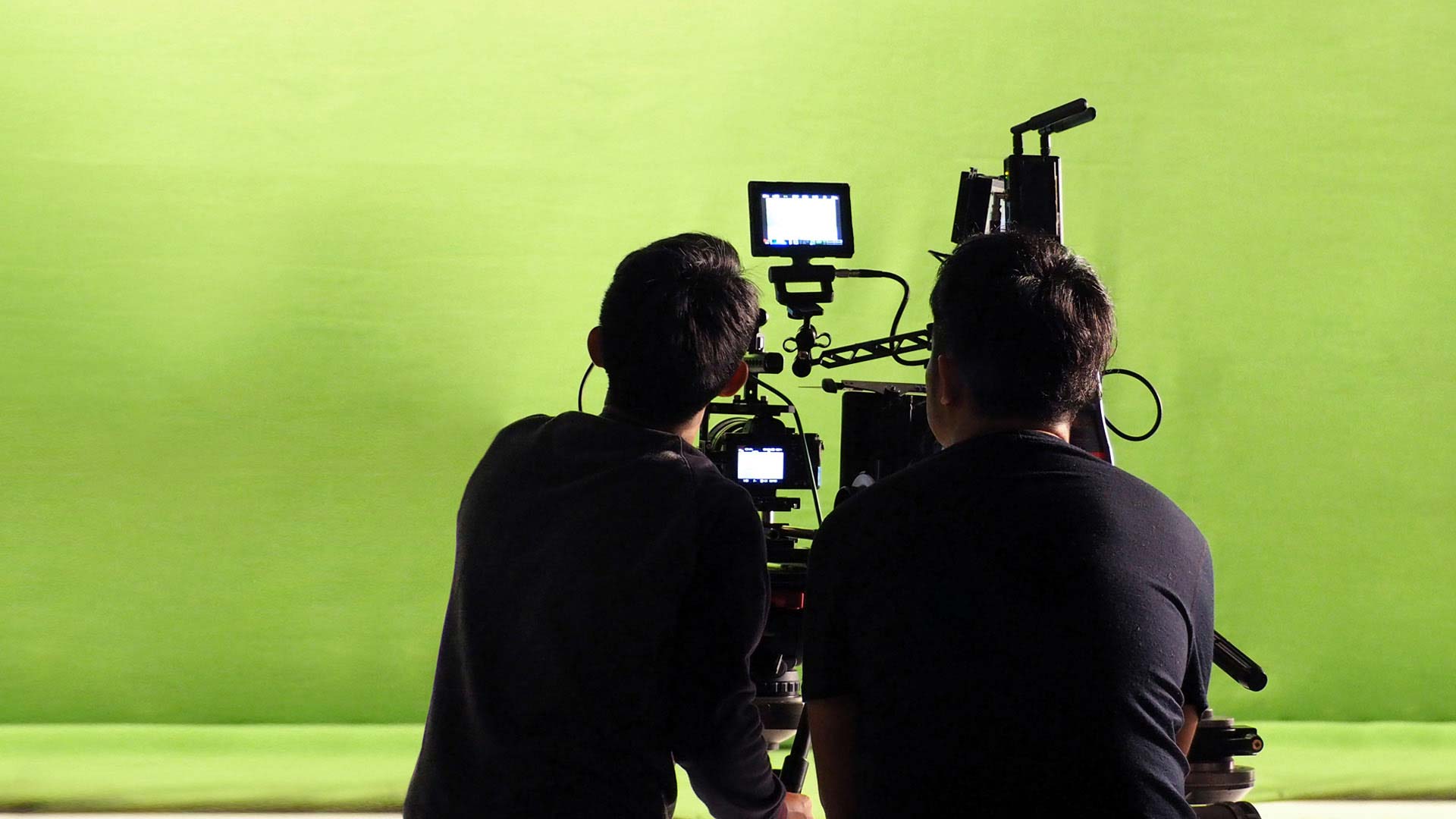 Filming on a greenscreen stage.