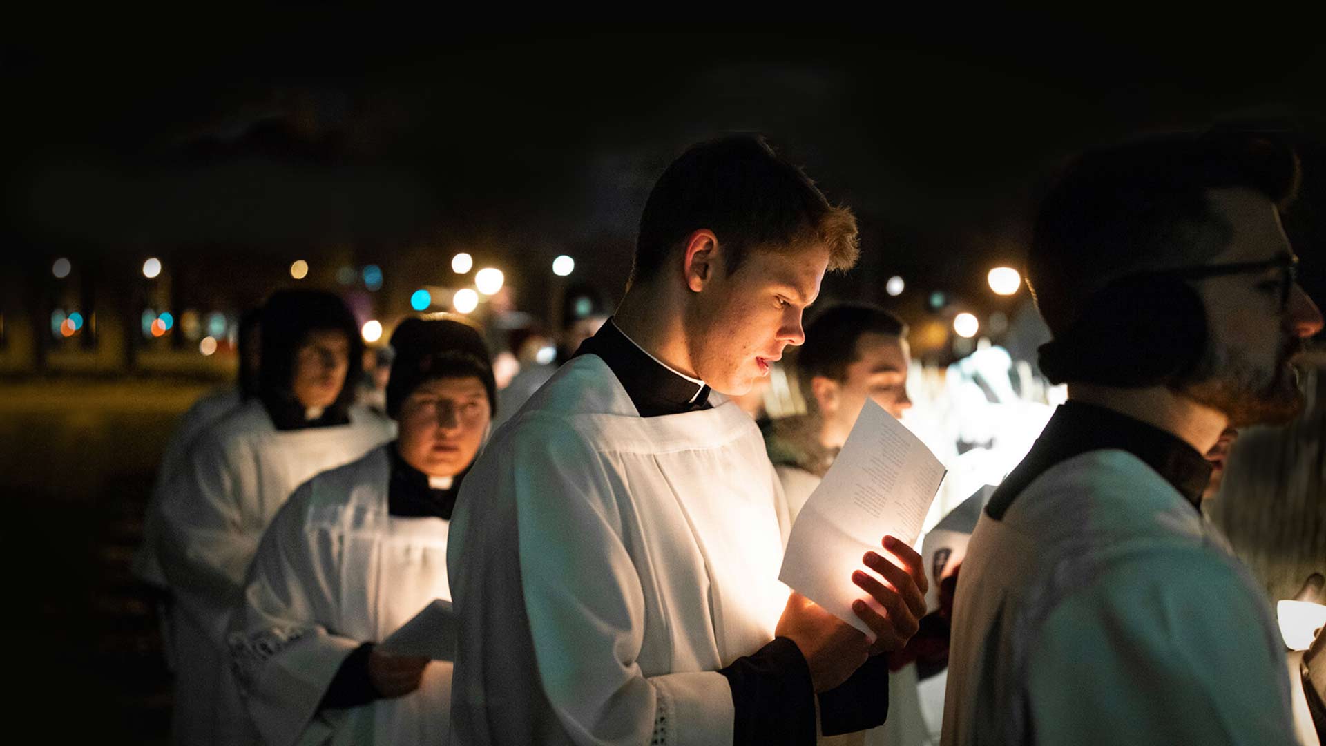Seminarians process at night