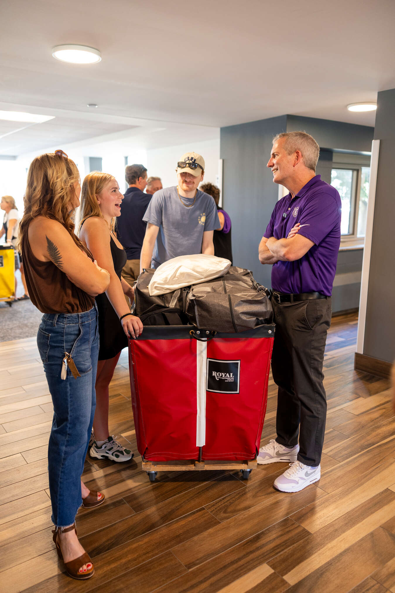 students smile while moving into residence halls
