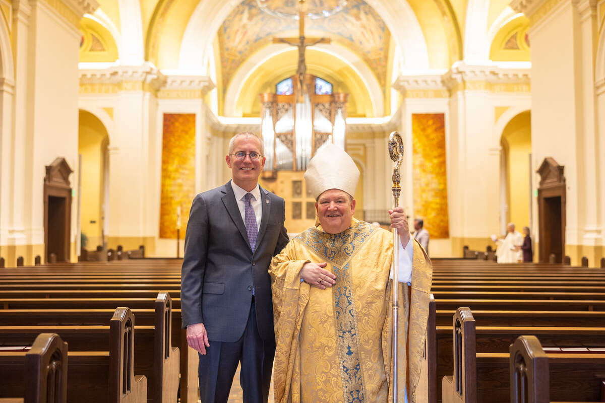 president rob vischer and archbishop joseph hebda smiling in chapel