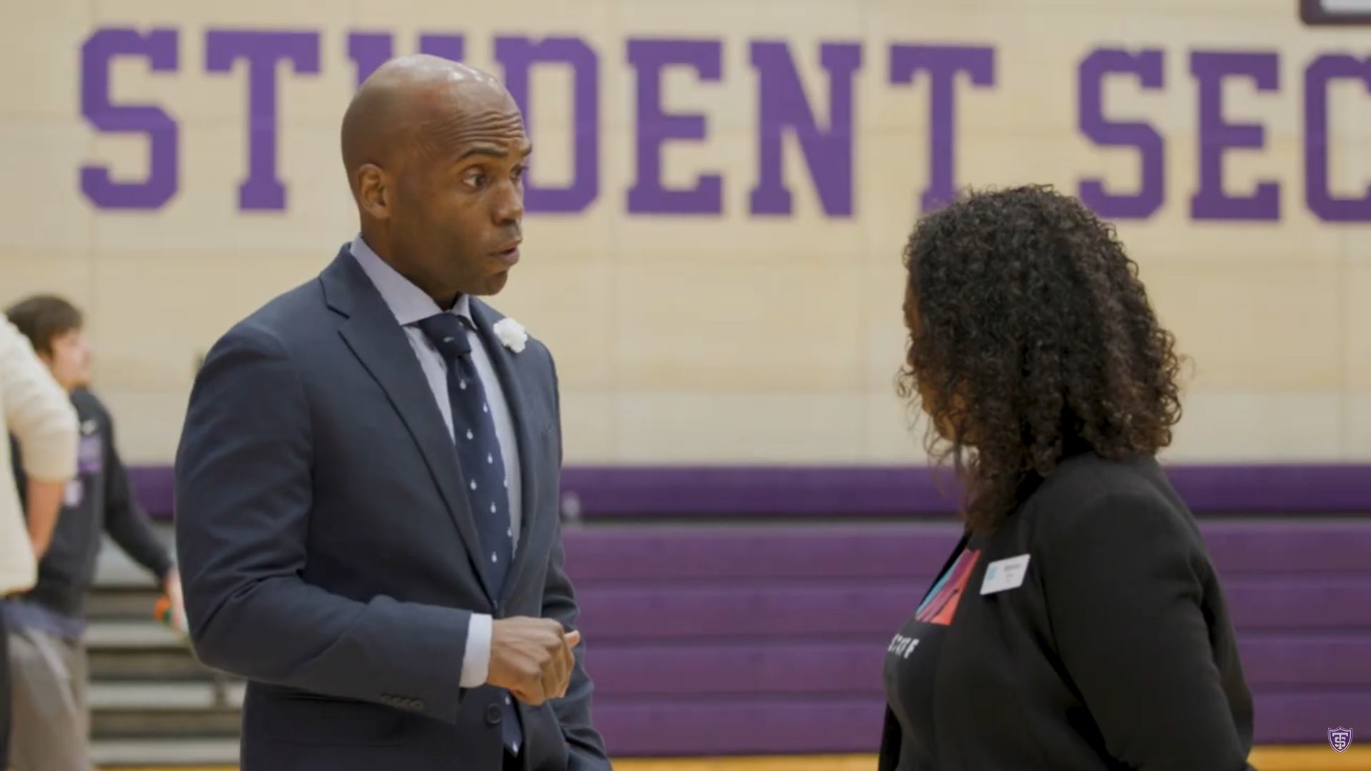 Yohuru Williams speaks with Bianca Jones of the Northside Achievement Zone at the St. Thomas basketball arena