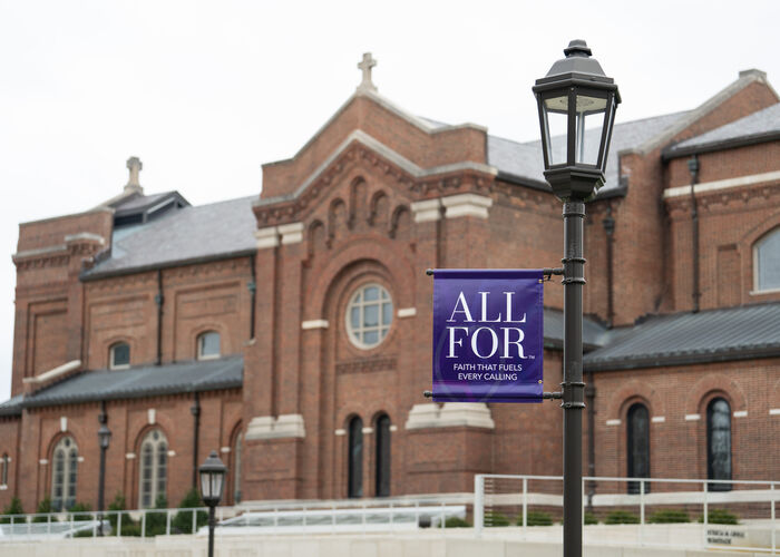 Banner saying "All For" hanging in front of the Chapel
