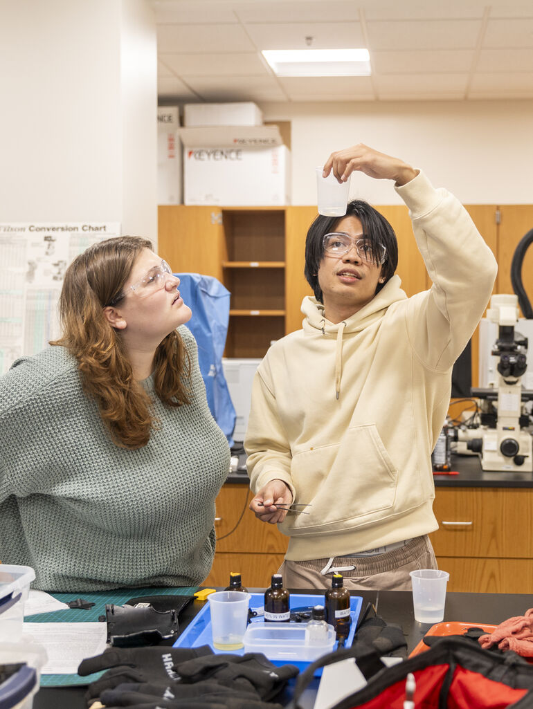 Students look at items in materials lab class in Schoenecker Hall 