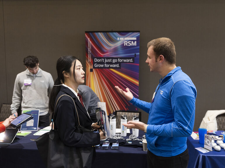 Student interacting with employer during career fair at St. Thomas 
