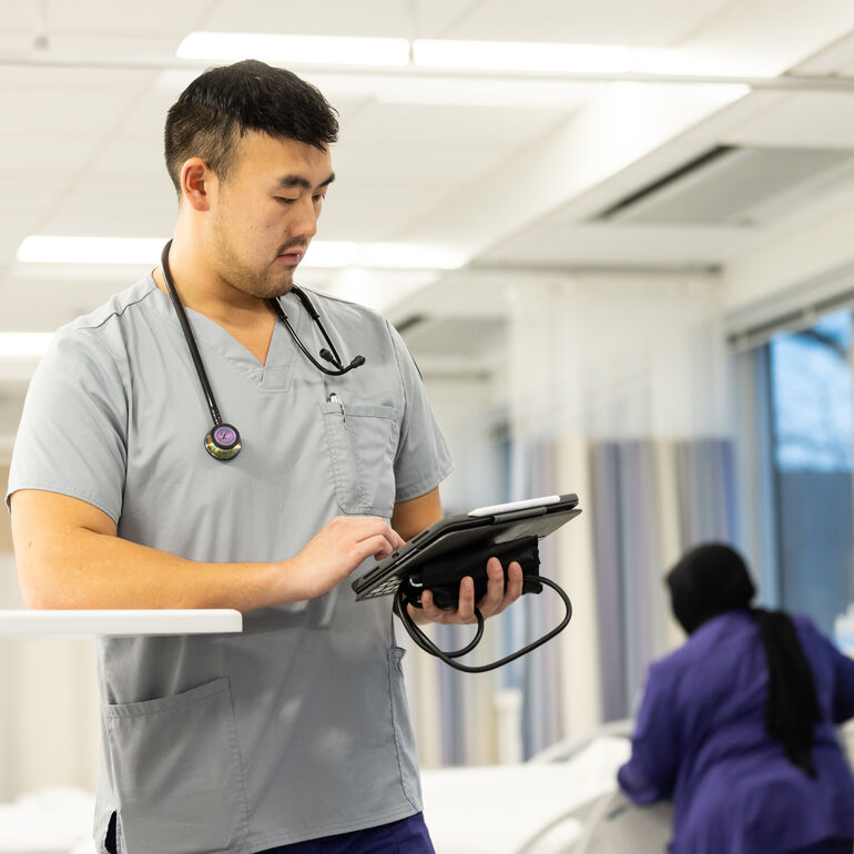 Nursing student looking at clipboard
