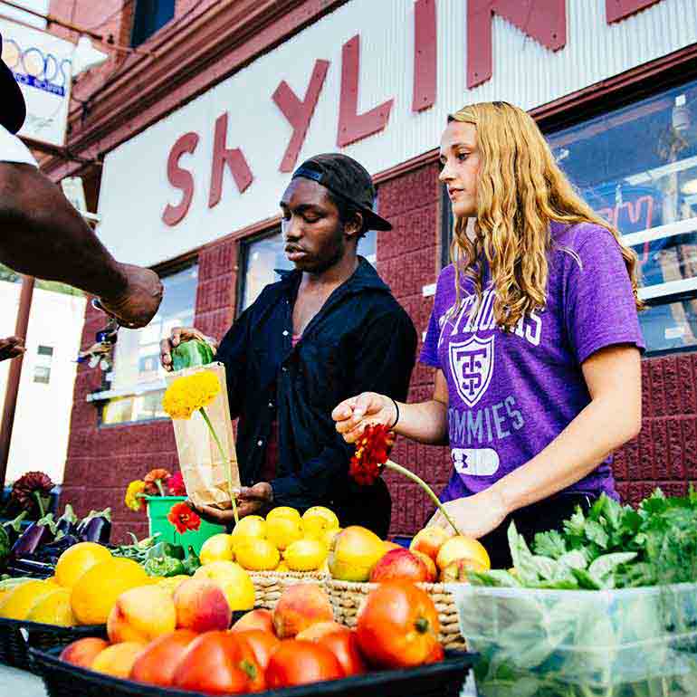 Two students work the Brightside Produce stand