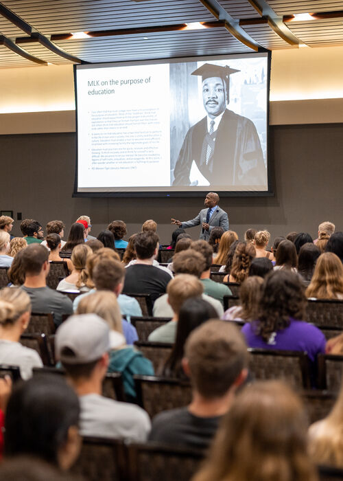 Large Lecture Hall of College Students Watching Presentation of MLK Jr.