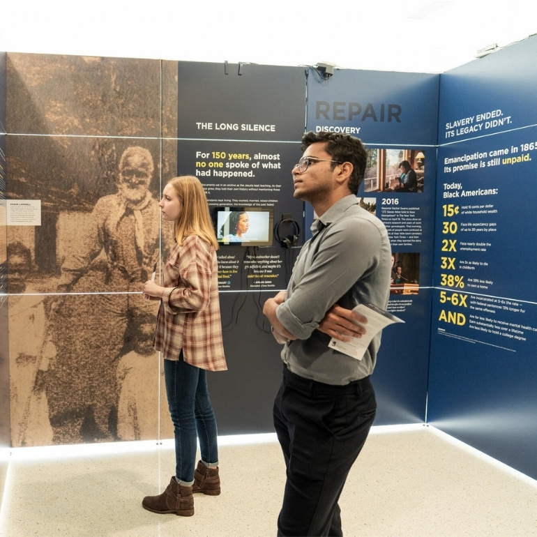 two students view the exhibit