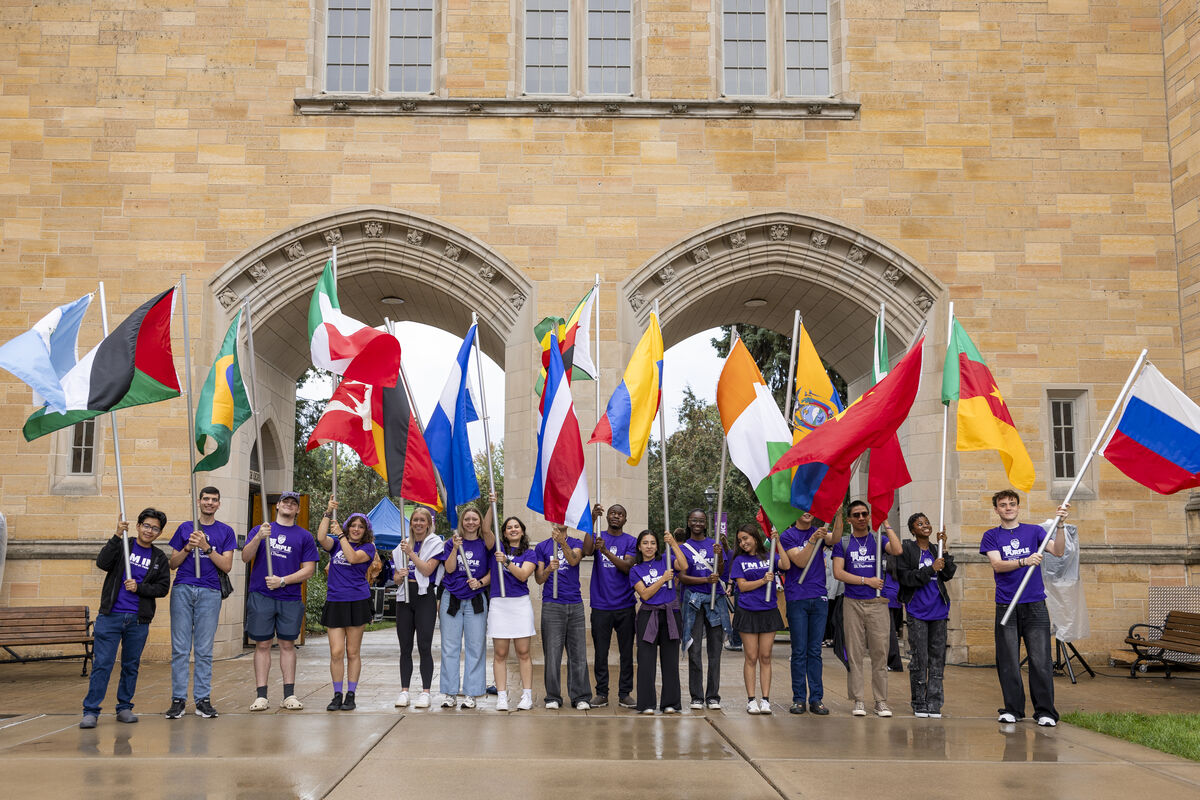 St Thomas international students hold flags representing their countries