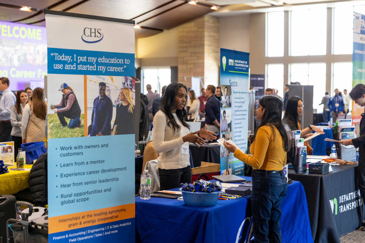 Student talks with a recruiter at a career fair