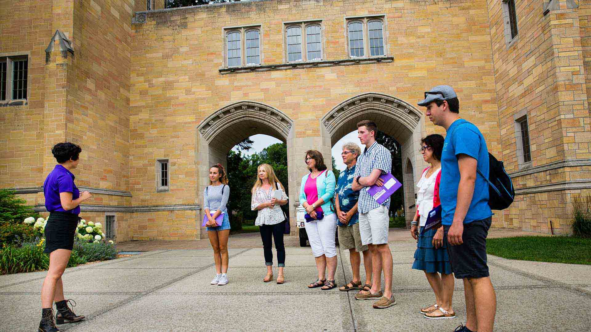 Tour guide gives a campus tour to high school students and parents. 