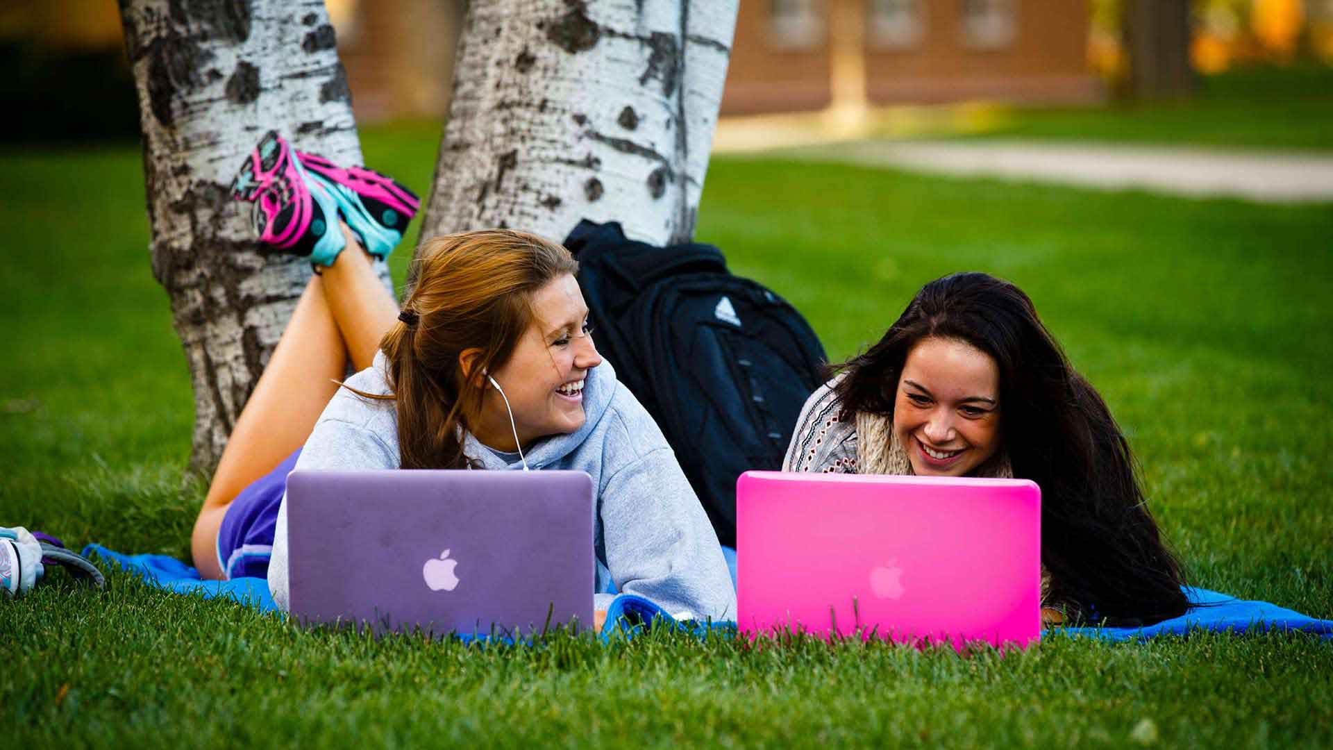 Freshmen Jenni King (right) Ellie Kalb use their laptops and smart phones on the upper quad.