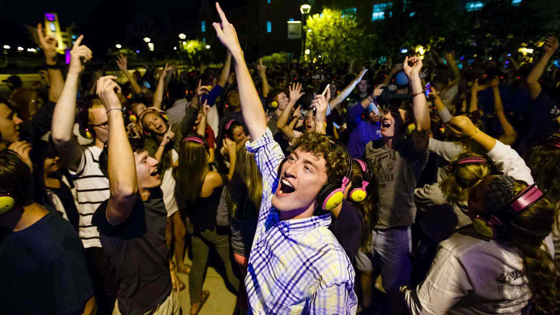 Students dance during headphone disco on the John P. Monahan Plaza. 