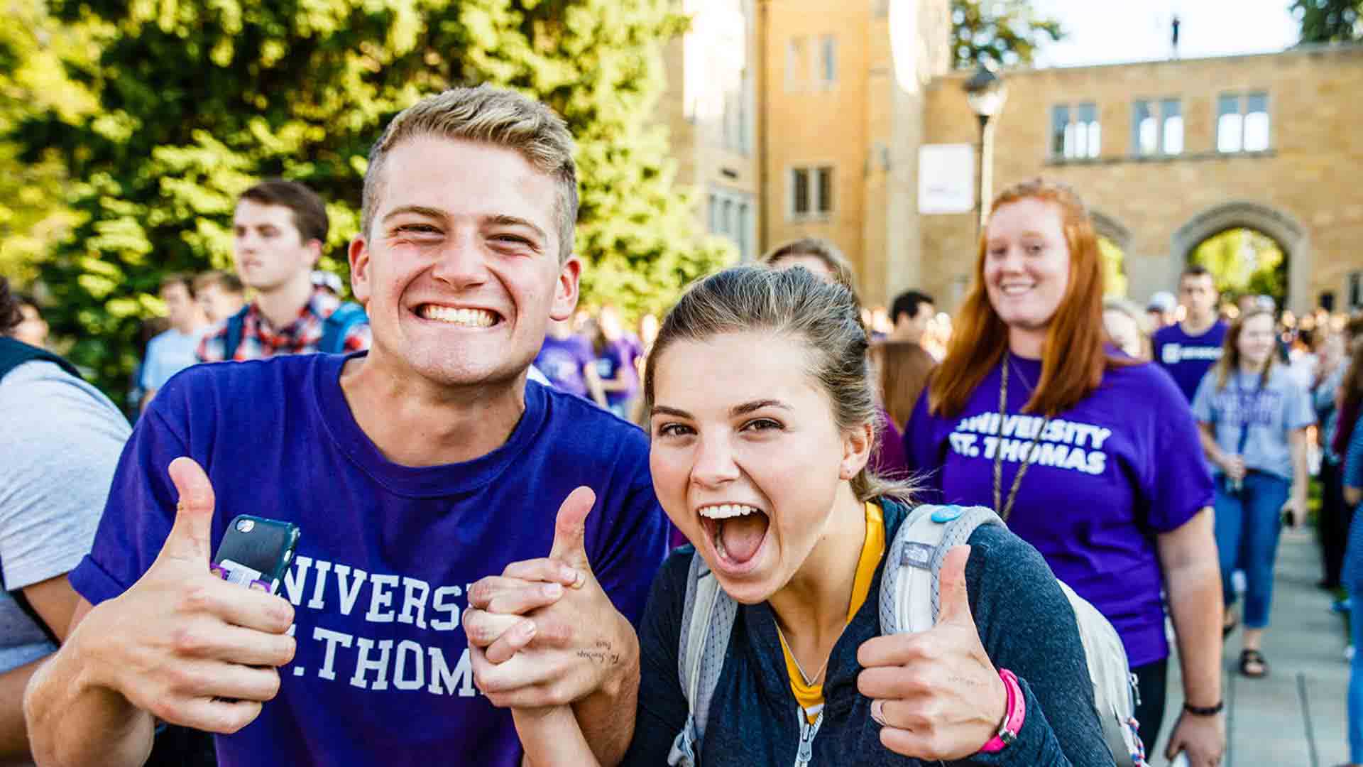 Students smile for the camera during the March Through the Arches in September.