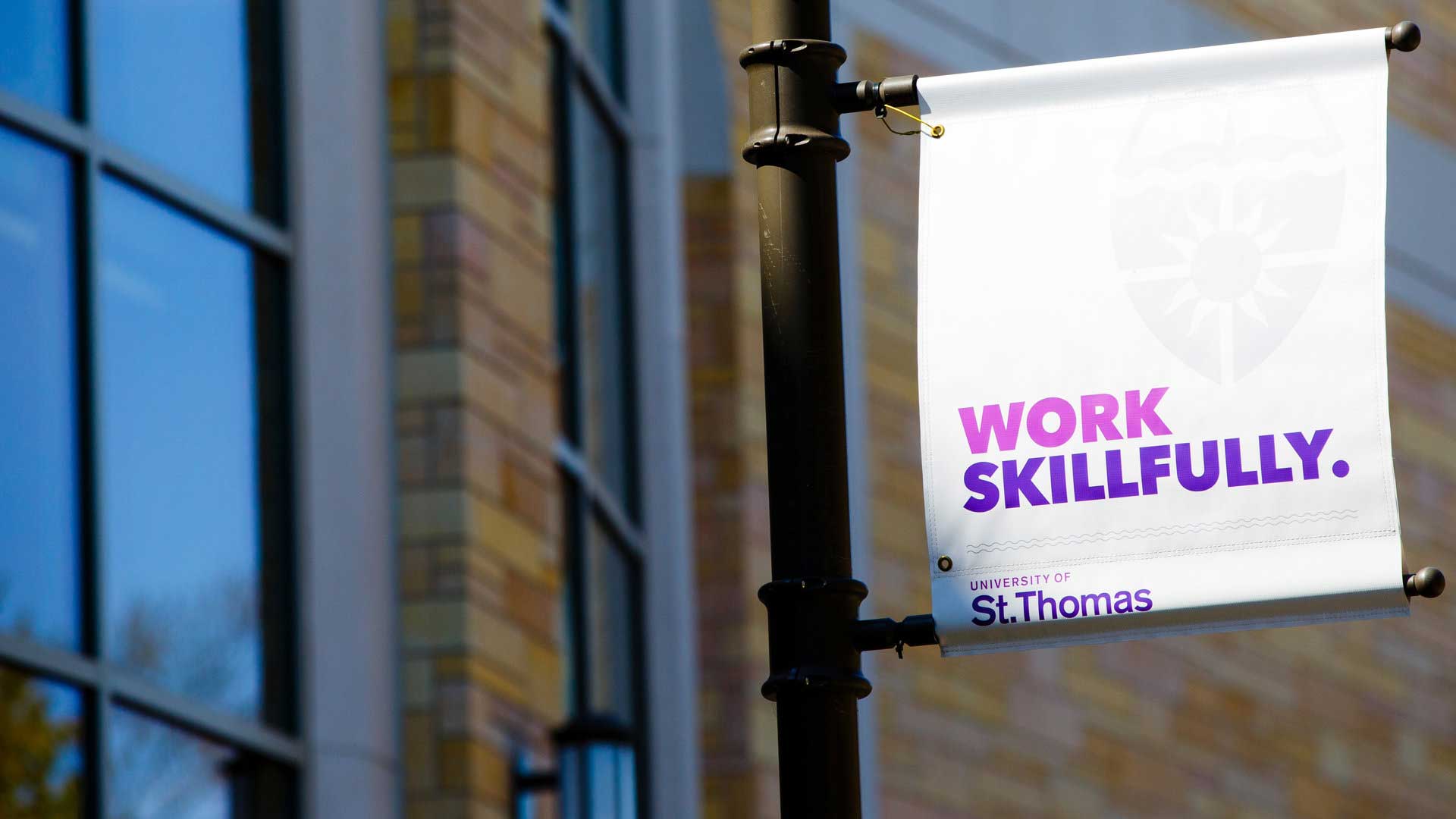 University of St. Thomas branded banner with text on it that says the following Work Skillfully. 