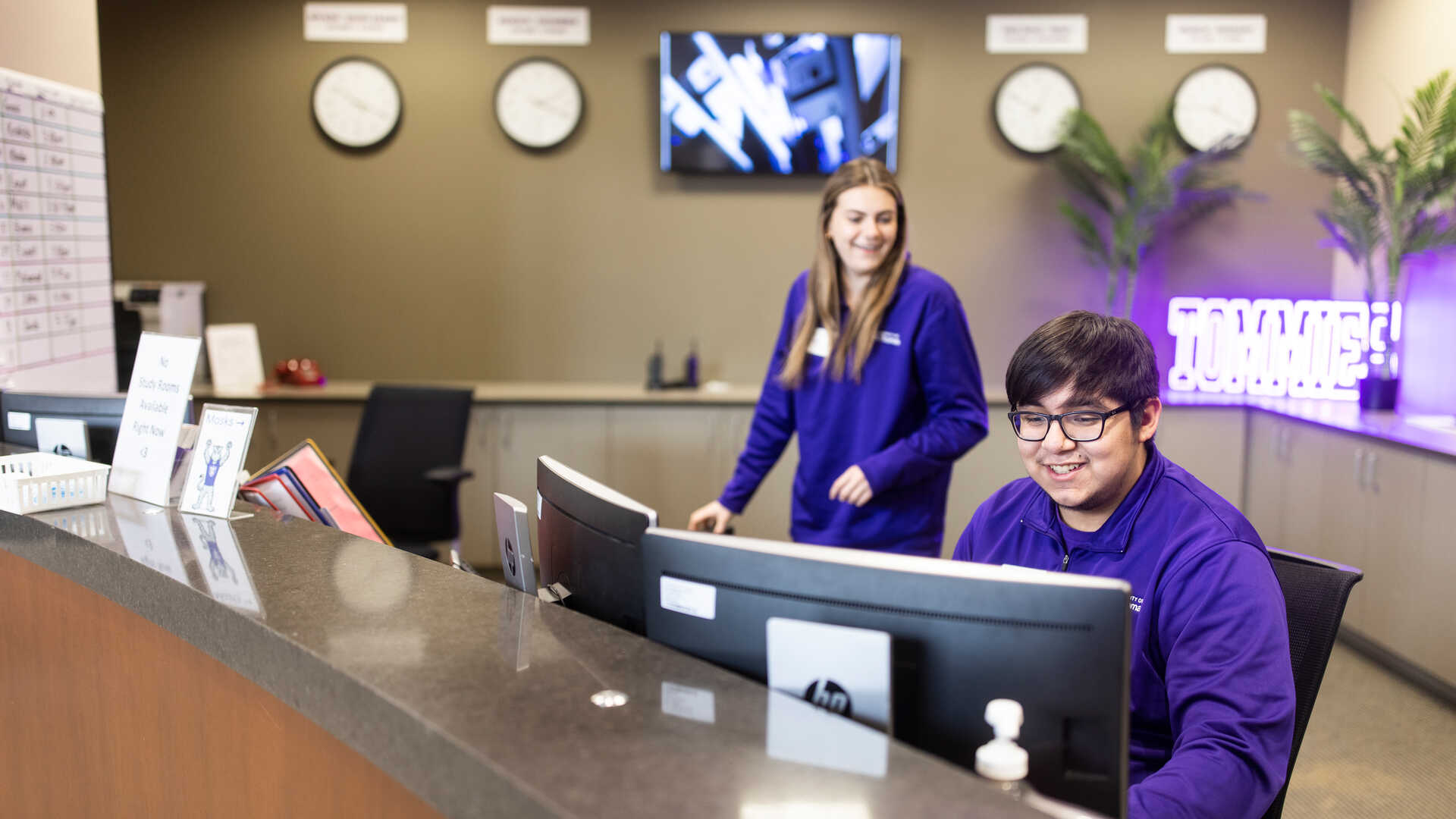 student employees work the desk of Tommie Central