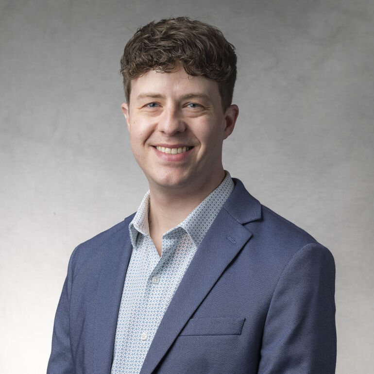 headshot of  Kyle Thomas