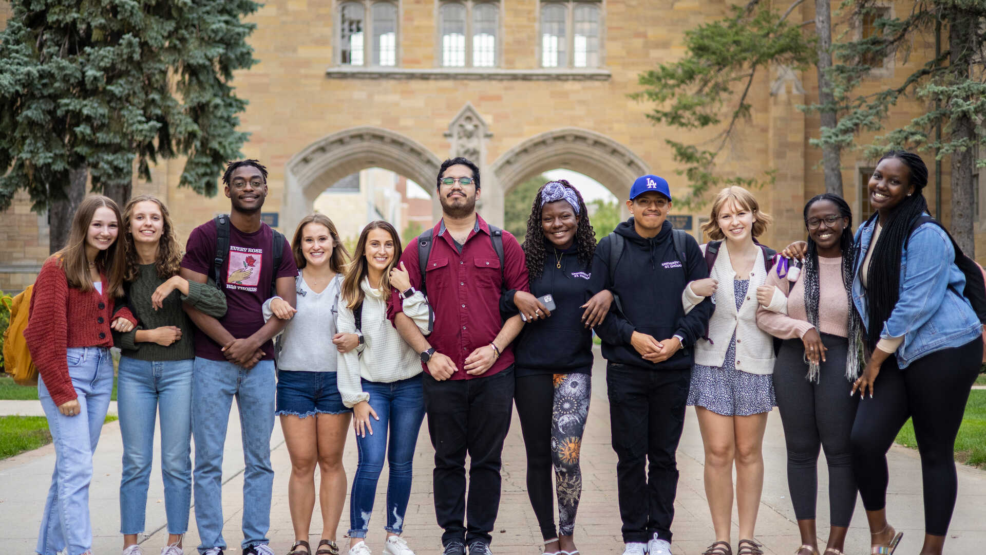 diverse group of students locking arms on st Thomas campus