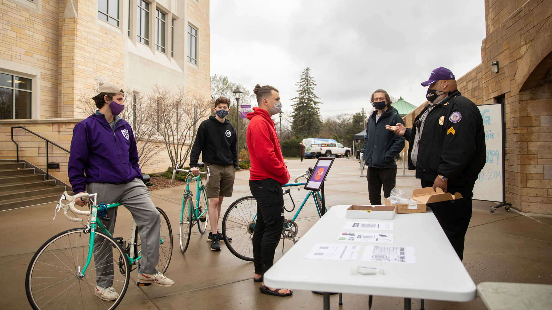 Public Safety staff interacting with students on bicycles