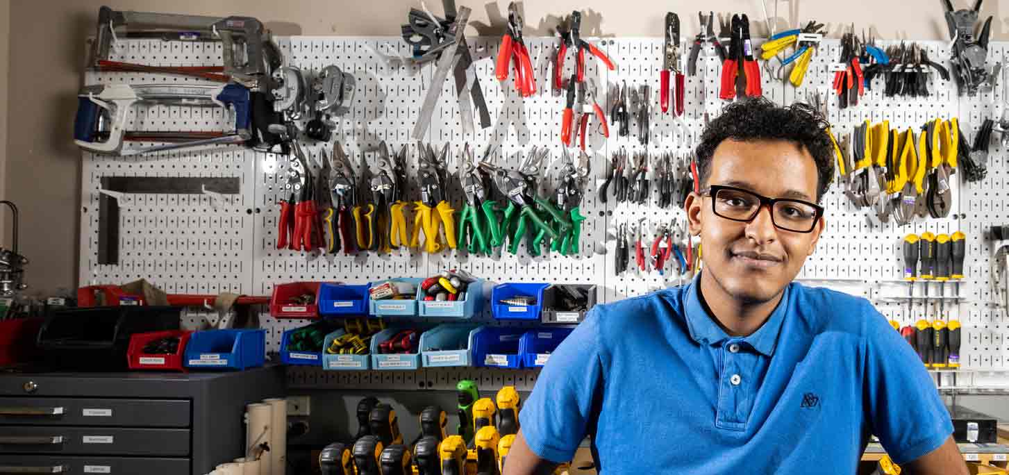 Senior and Electrical Engineering major Mahamud Hussein stands for a portrait in the Tool Crib of O’Shaughnessy Science Hall on June 9, 2021.