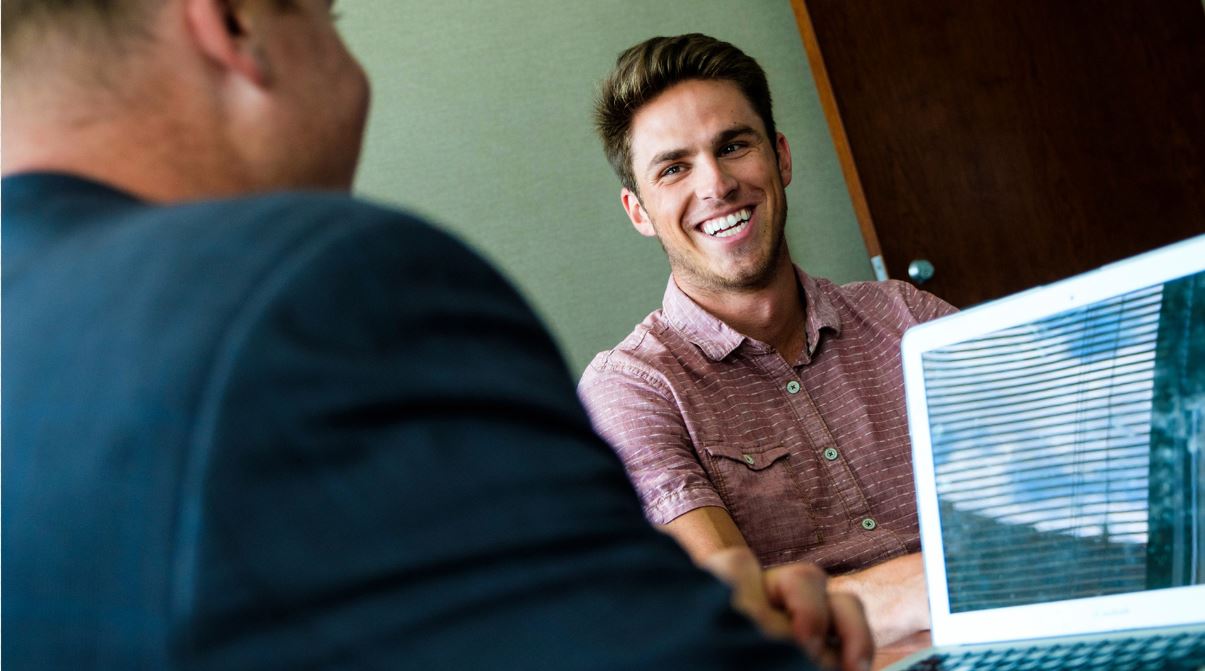 A smiling candidate is talking to an employer