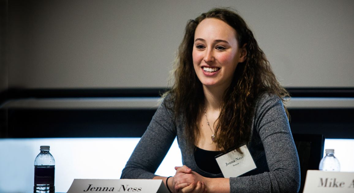 A panelist speaks to a crowd