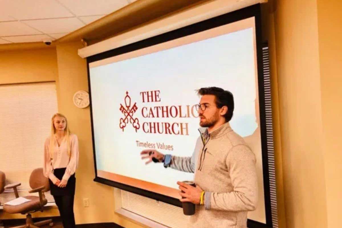 Students present on their advertising campaign for the Catholic Church.