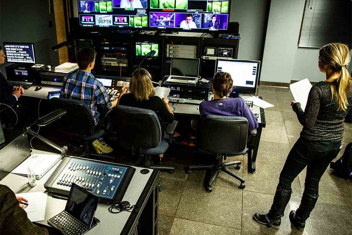 Journalism students work in the control room during production of the TommieMedia program "The Locker Room" in the TV studio.