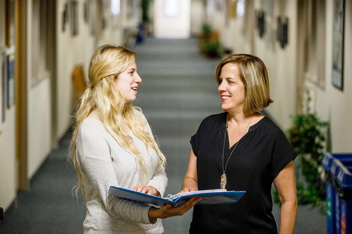 English professor Alexis Easley (left) and student Shannon Kelly converse during a staged scene in the John Roach Center November 2, 2015. Taken to promote English department mentor programs. 
