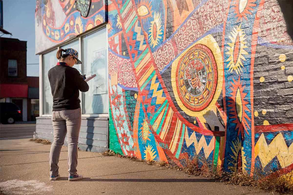Students and faculty collaborate on a mapping and documentation project at a mural