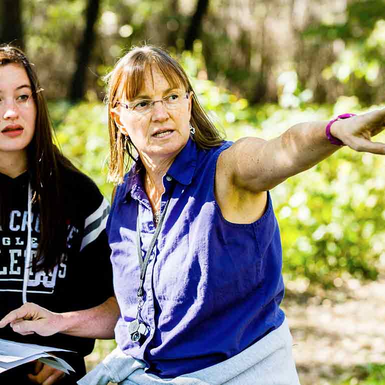 Professor Melissa Lamb instructs students at Hidden Park Falls.
