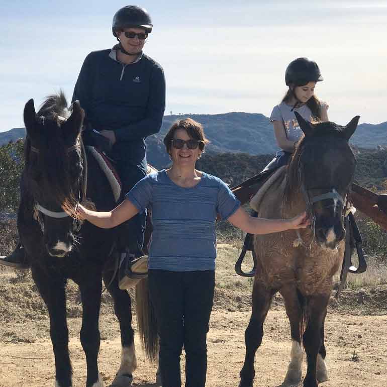 Dr. Habiba Hadziavdic standing between two horses