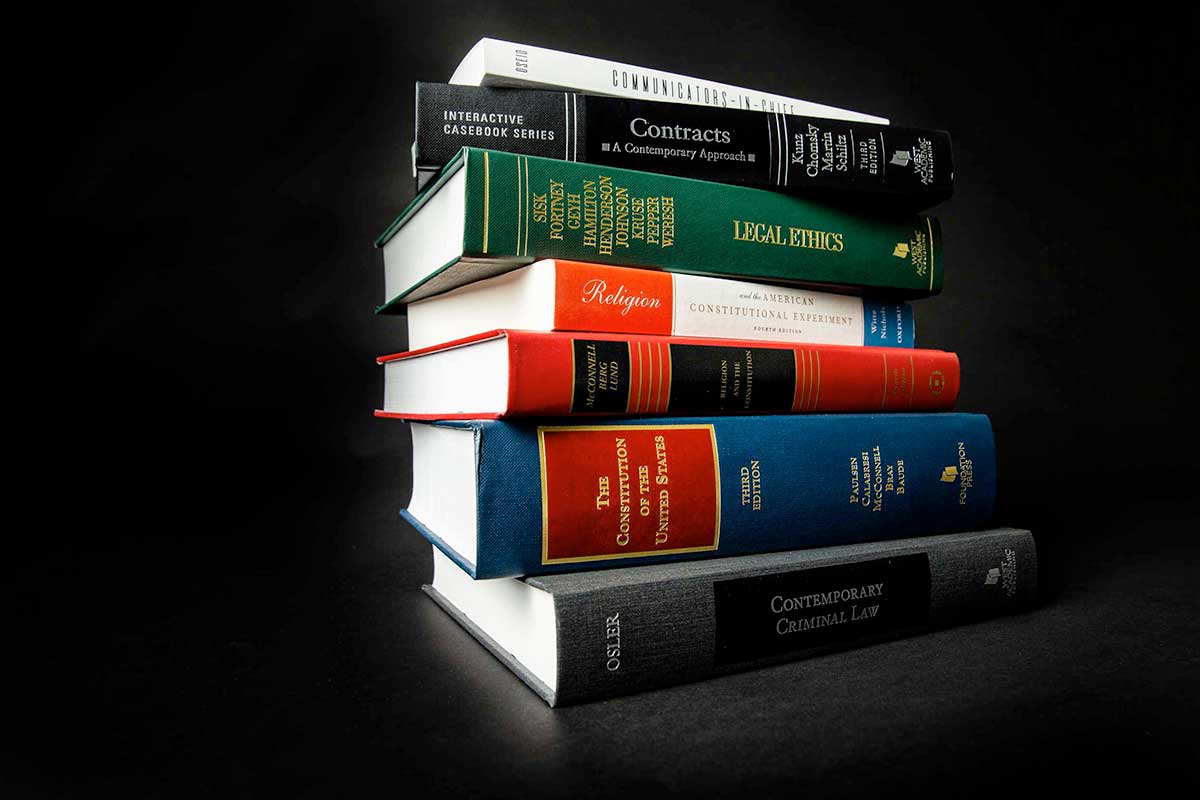 A stack of books authored by School of Law faculty.