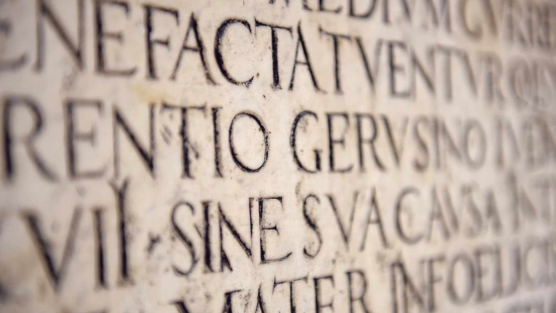 Latin words carved on the wall.