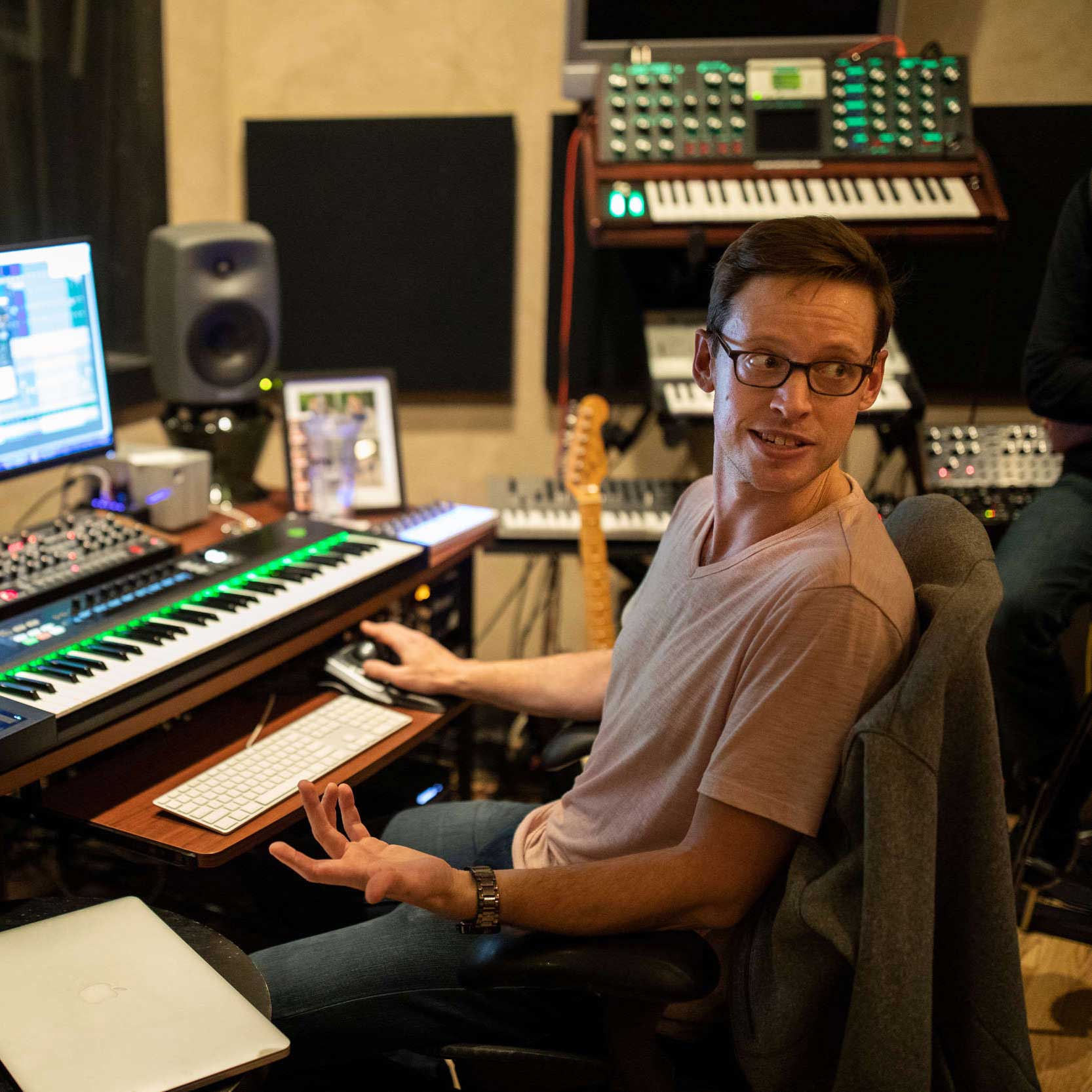 Brian Casey sits at his work station during a music business class tour of "In the Groove Music" studio in downtown Minneapolis.