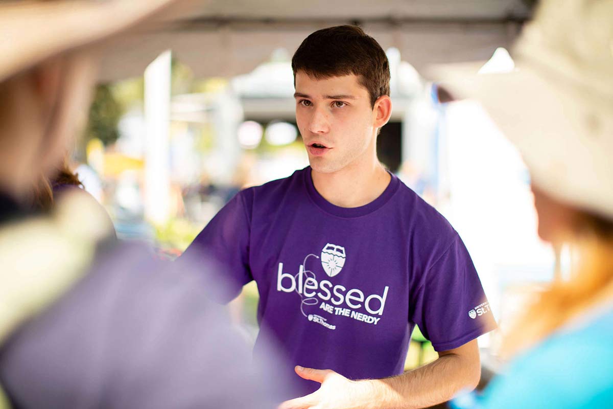 Student Teo Grieder works at the University of St. Thomas STEM booth