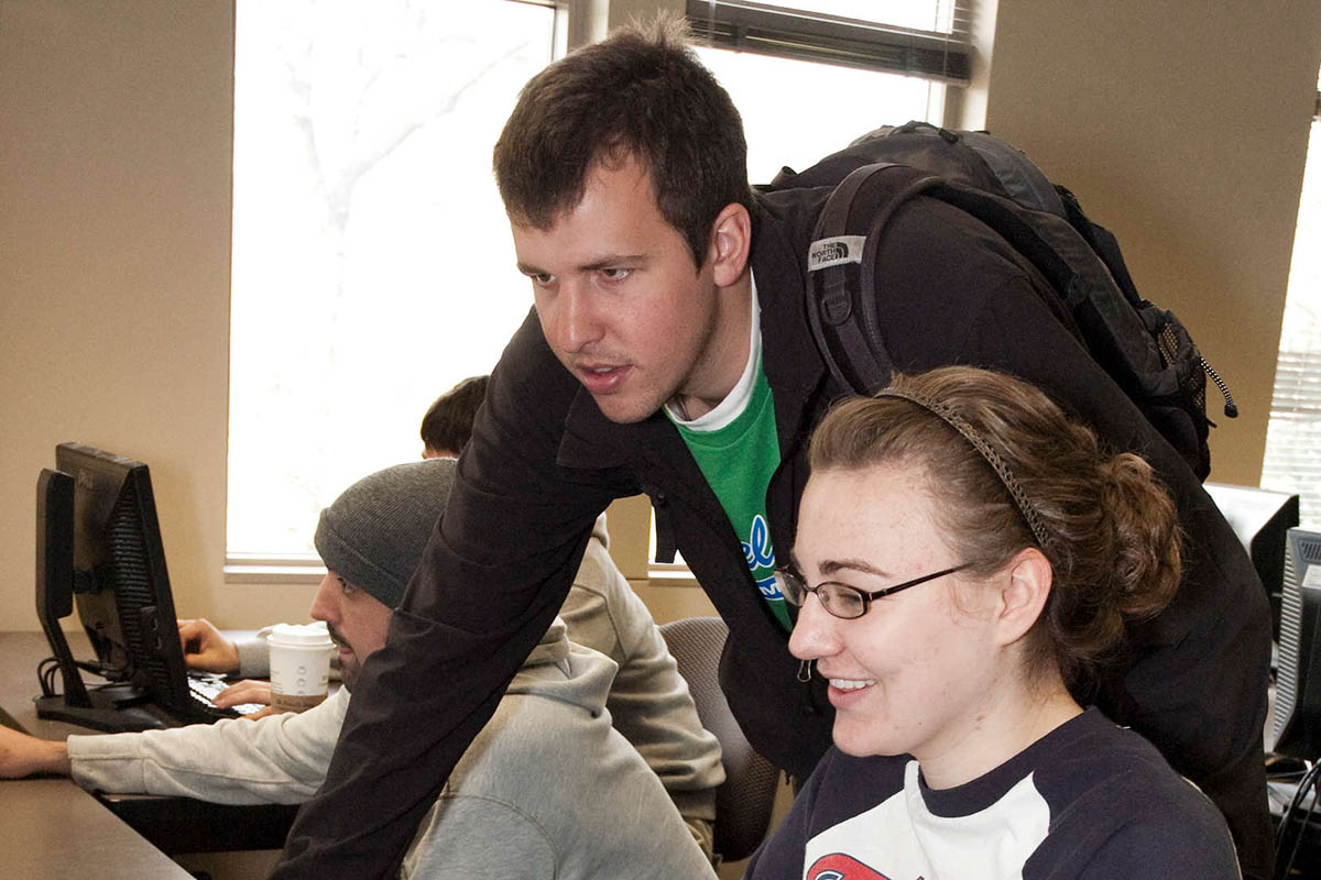 Students looking at a computer.