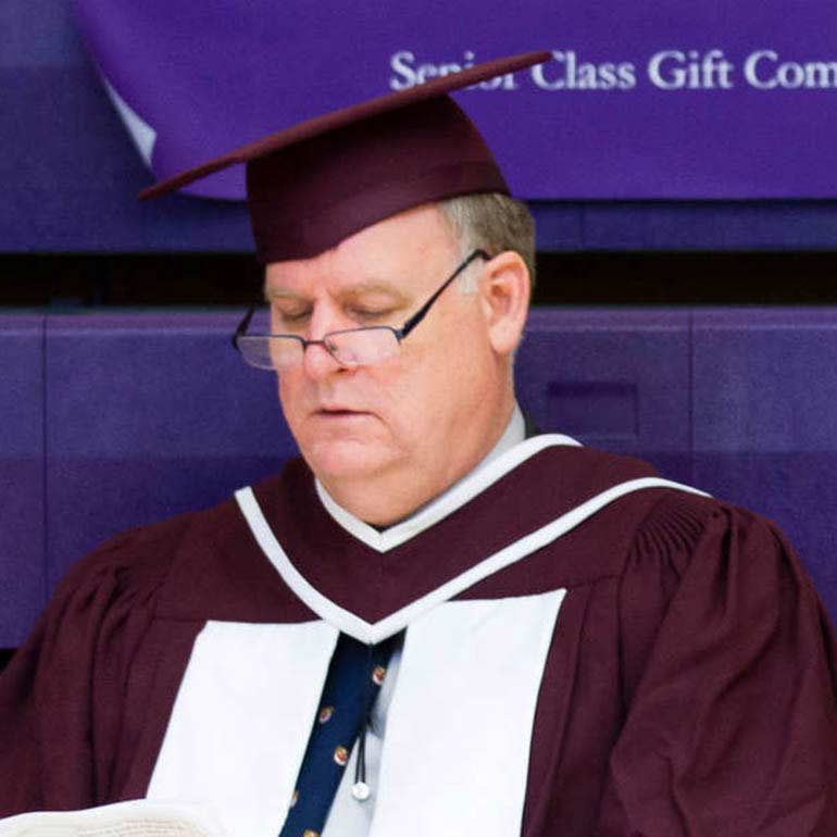 John Martens in cap and gown at a commencement exercise.