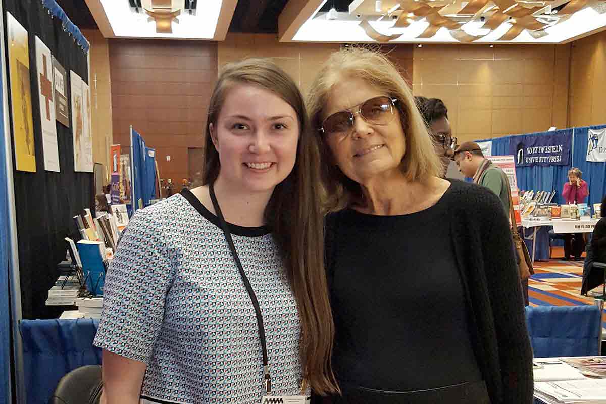 A women's studies student poses for a photo with Gloria Steinem.