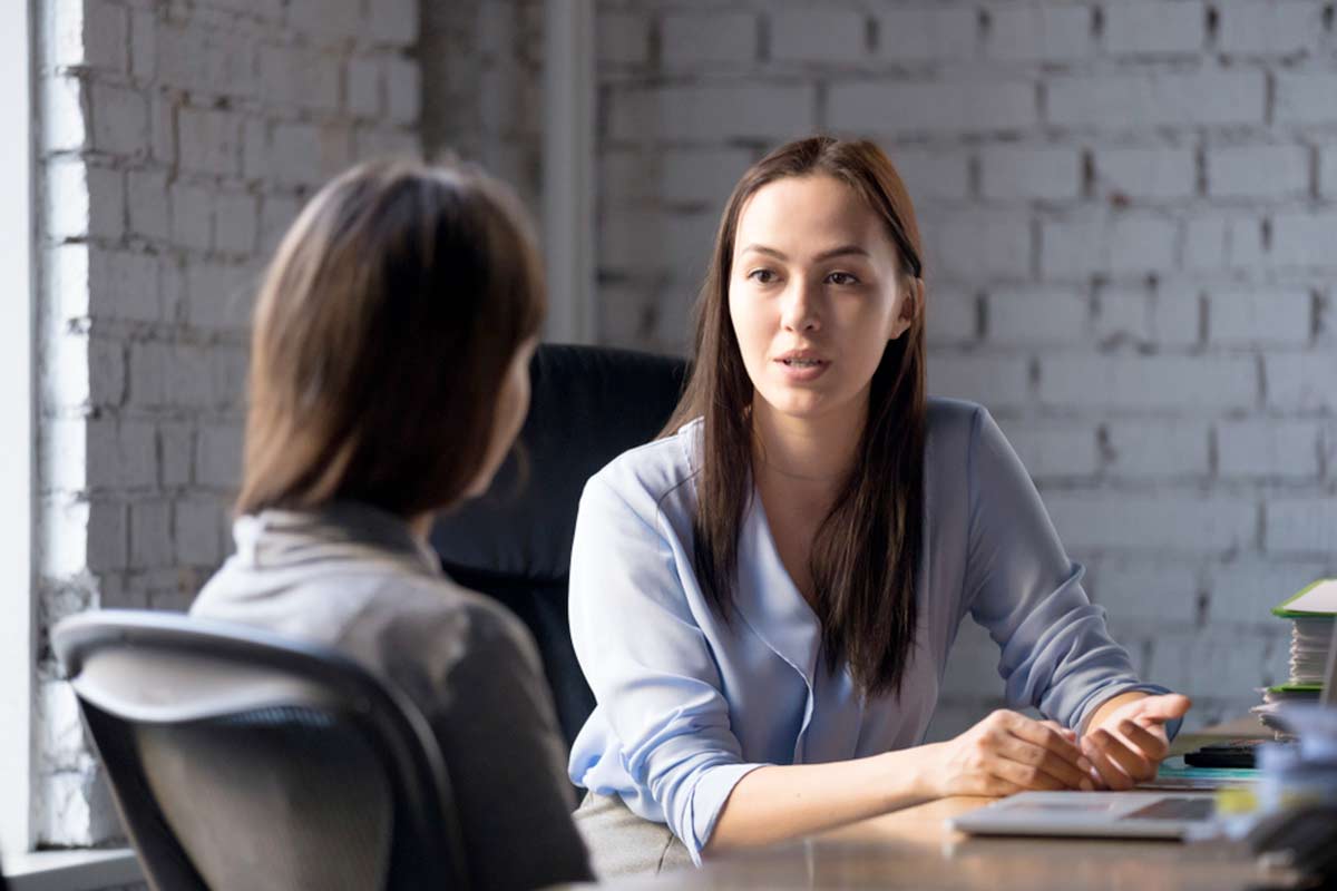 A woman giving advice to customer in a meeting room.