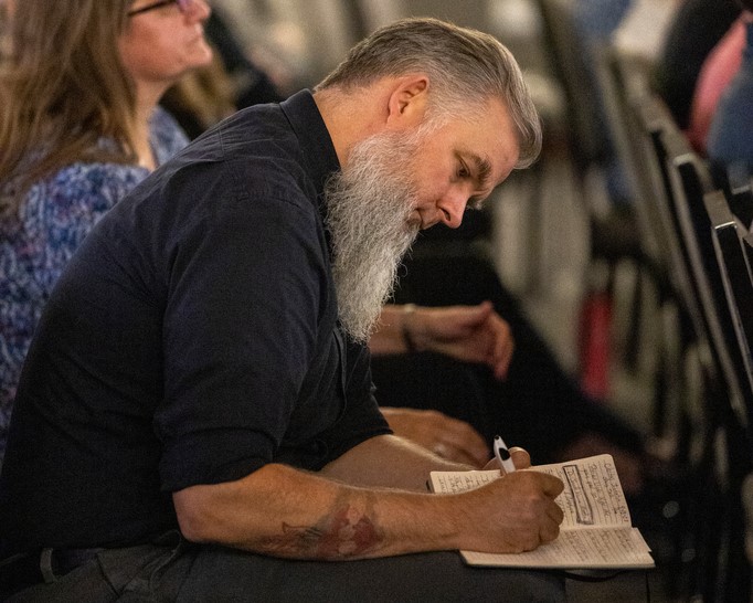 person taking notes during the event