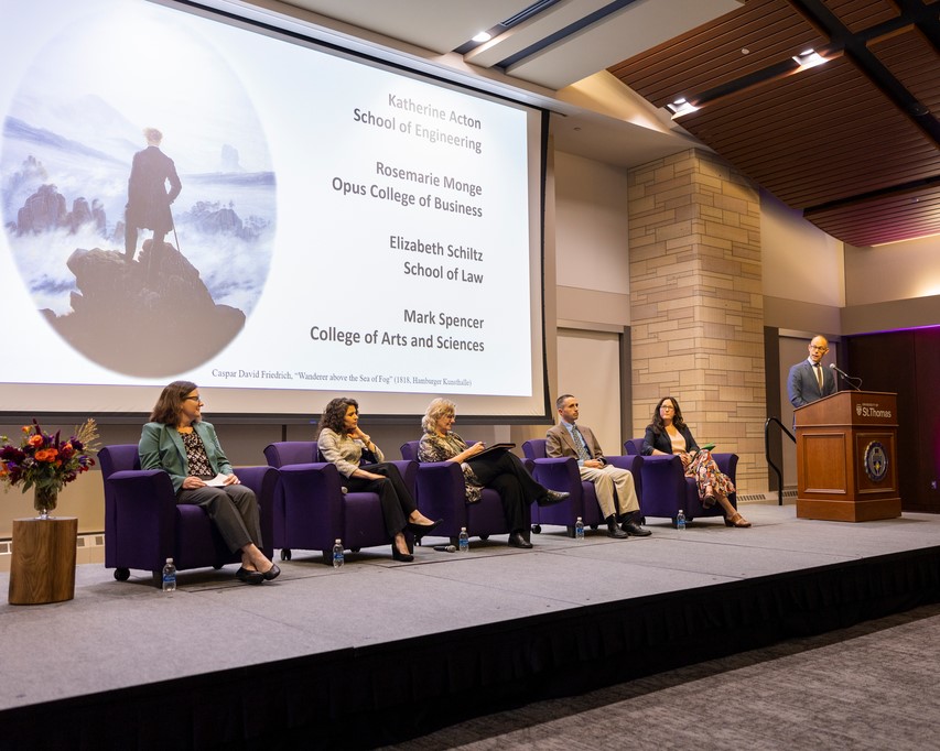 panel of speakers onstage at the event