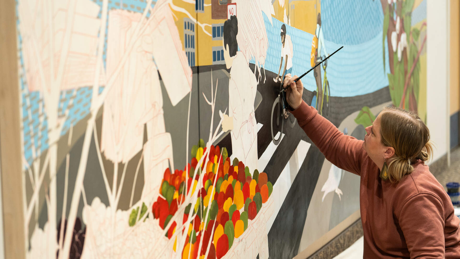 Artist Jessica Turtle in the process of painting a mural.