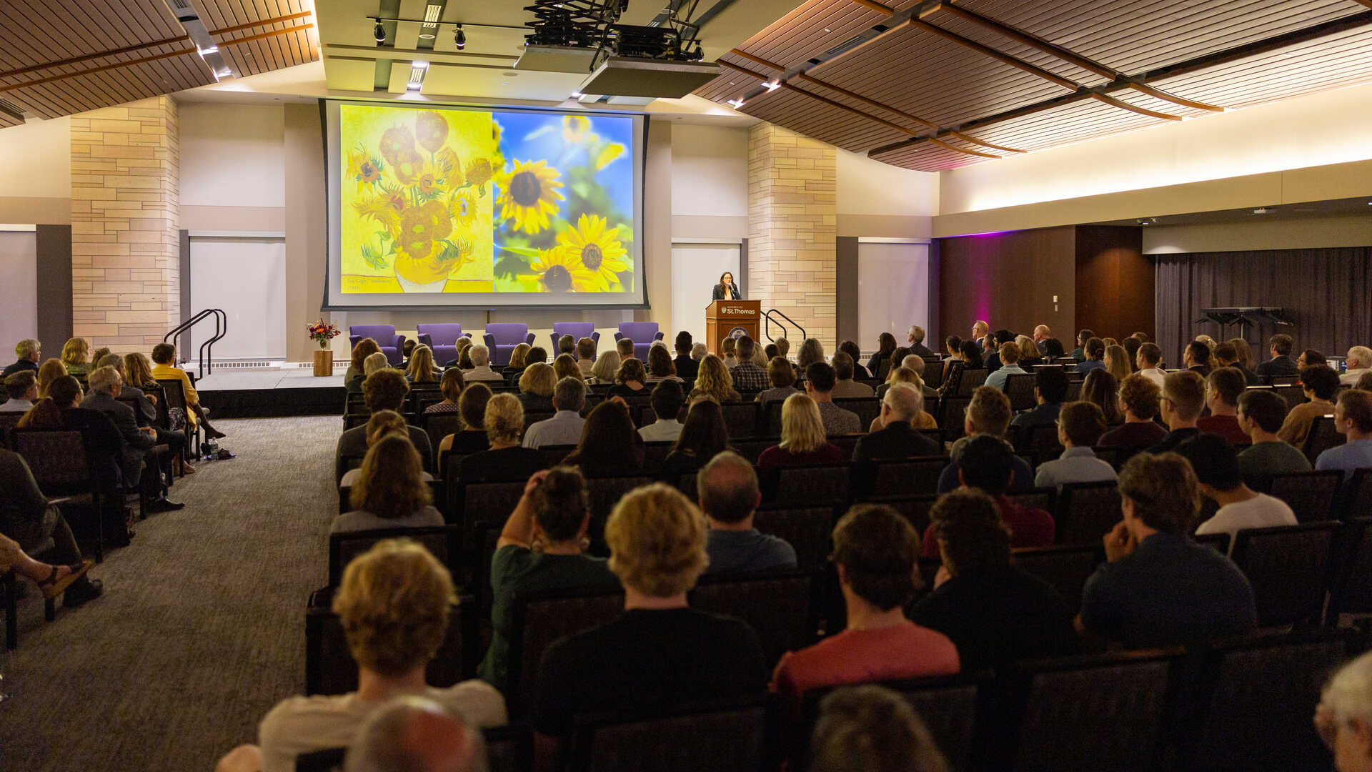 Dr. Jennifer Newsome on stage speaking at the event
