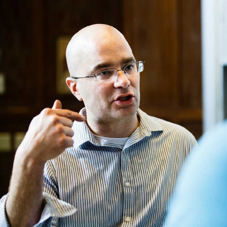 Dr. John Abraham speaks with a student.
