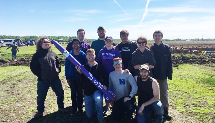 St. Thomas Rocket Club with UST purple rocket.