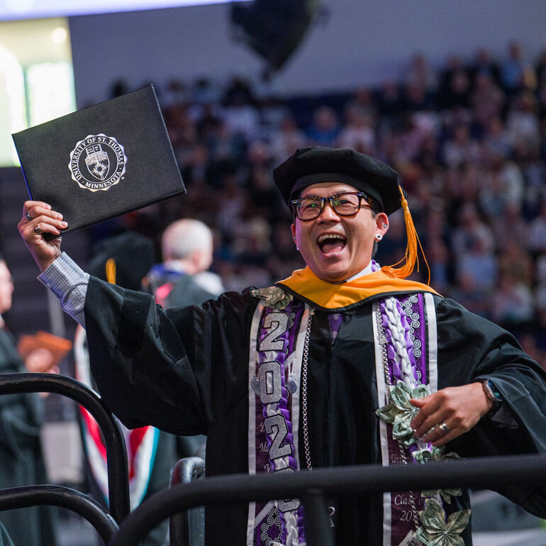 Graduate rejoicing as they cross the stage