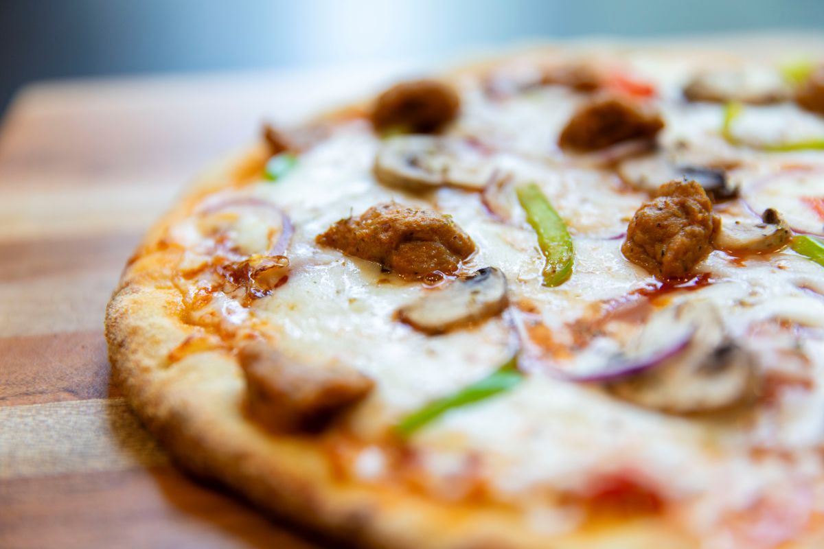 Meat and Veggie Pizza on Butcher Block Wood Table