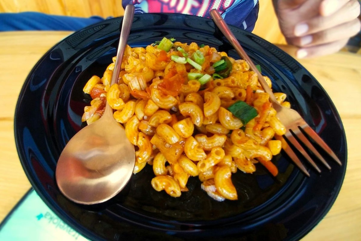 Mac and cheese on dark blue plate with spoon and fork