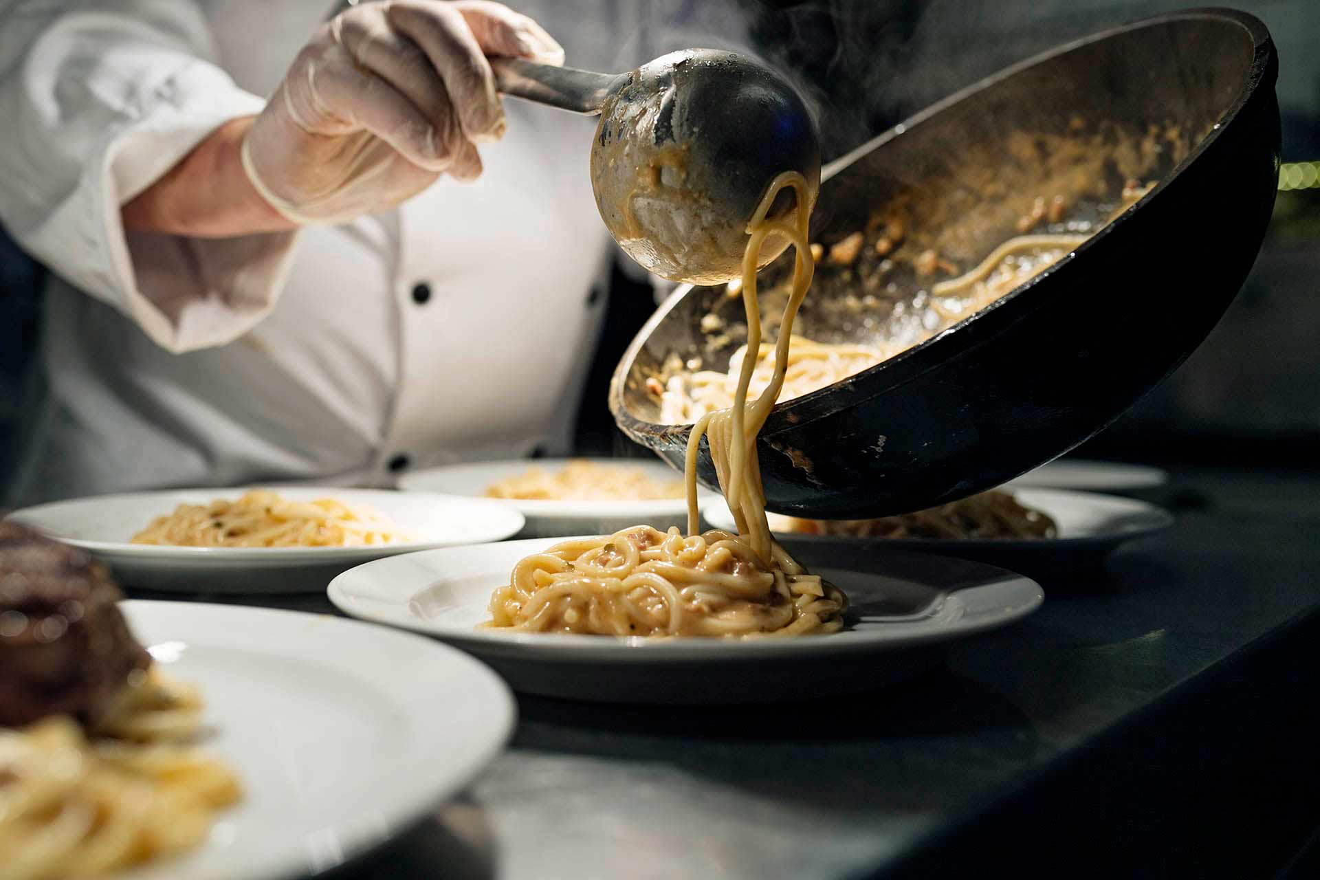 Pasta being served from a pan